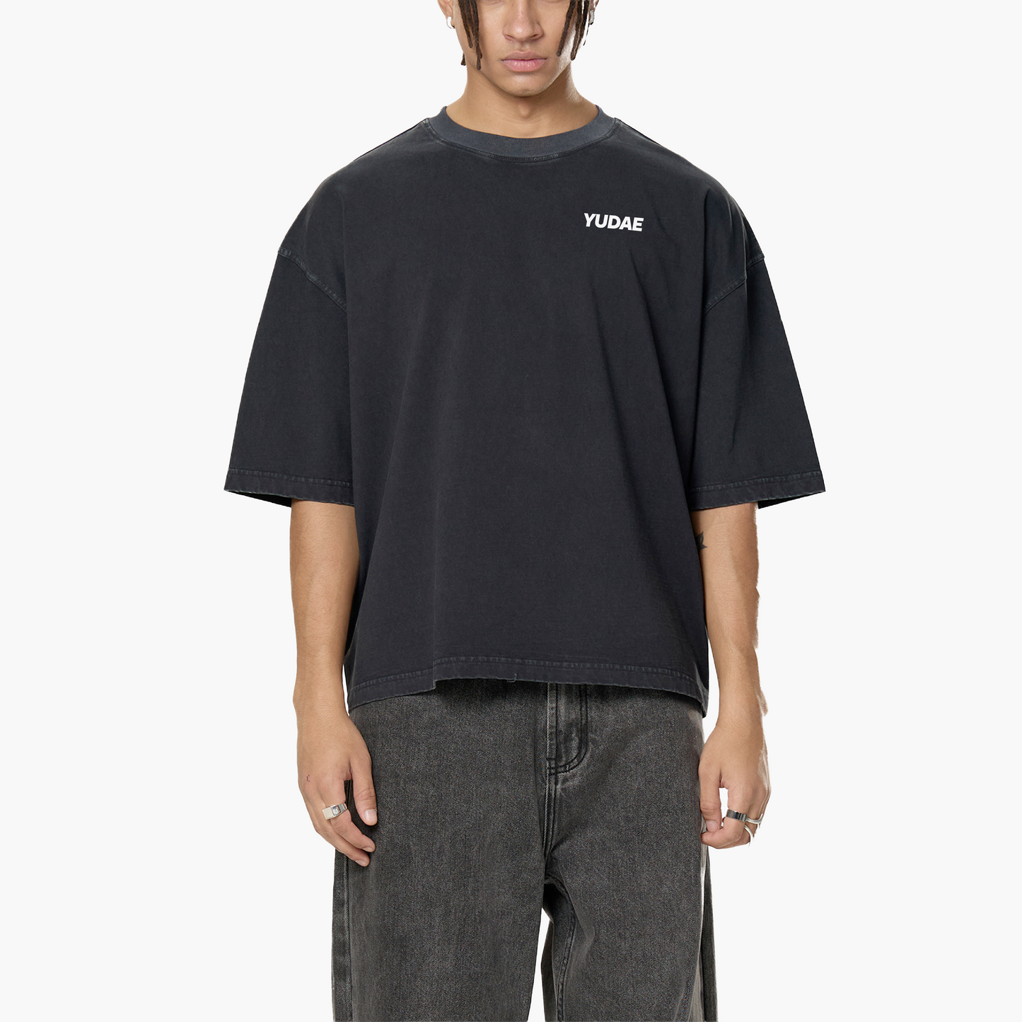 Person wearing a black t-shirt with 'YUDAE' logo on a white background