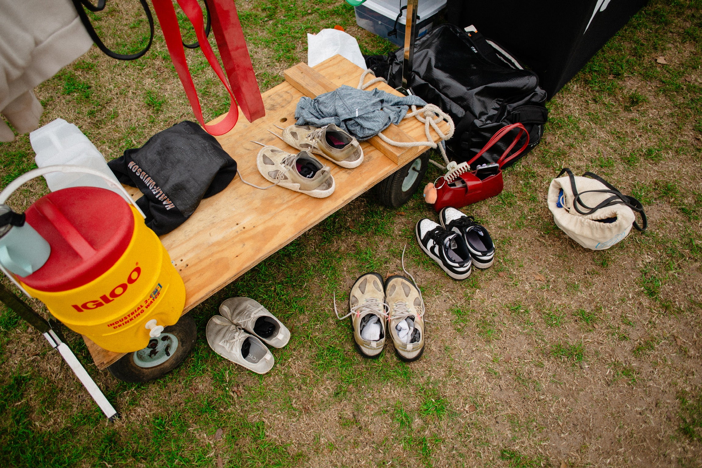 top down wide angle photograph of shoes splayed out on grass lawn during yudae wellness outdoor gym