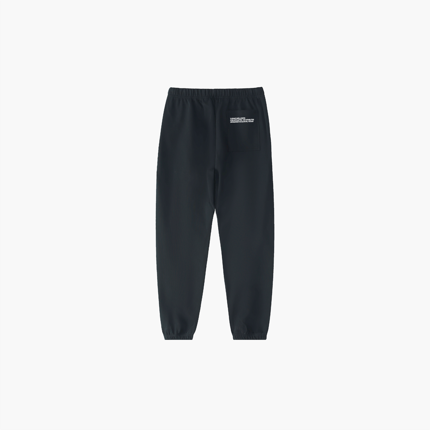 Black sweatpants with a small white logo on a light gray background