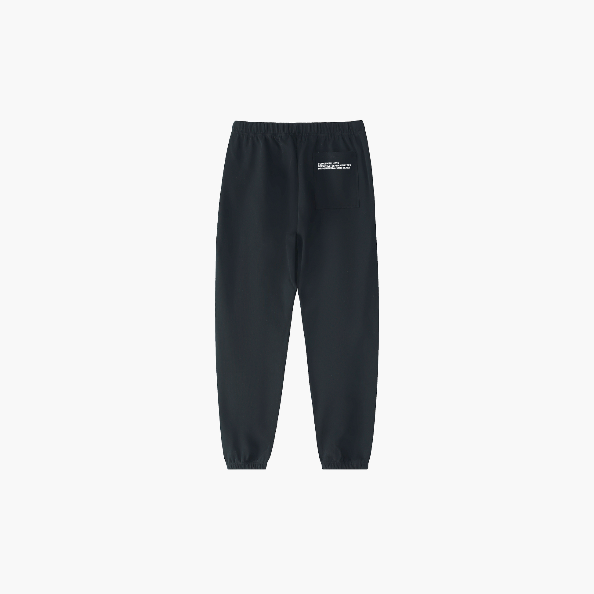 Black sweatpants with a small white logo on a light gray background