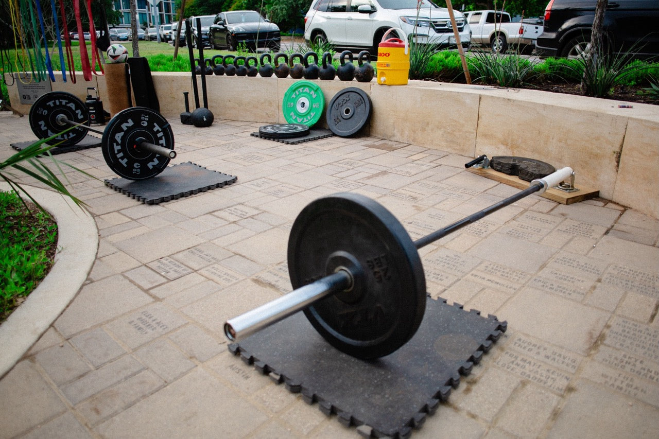 weights laid out at yudae wellness outdoor gym
